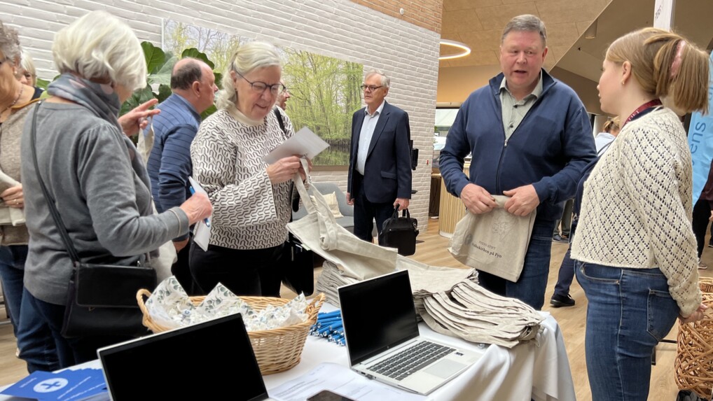 Fyens Stifts jurist i samtale ved stand, hvor folk tager flyers og muleposer